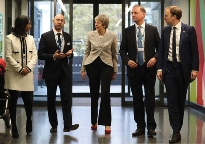 Theresa May and health secretary Matt Hancock far right with from left GP partner Dr Jonathan Levy and Simon Stevens