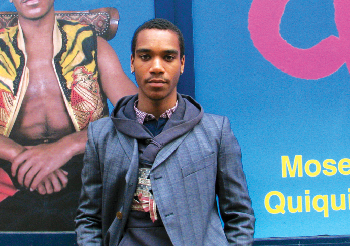 Thread Perry: how Moses fuses fashion and art Moses Quiquine next to exhibition hoarding A Cobbinah