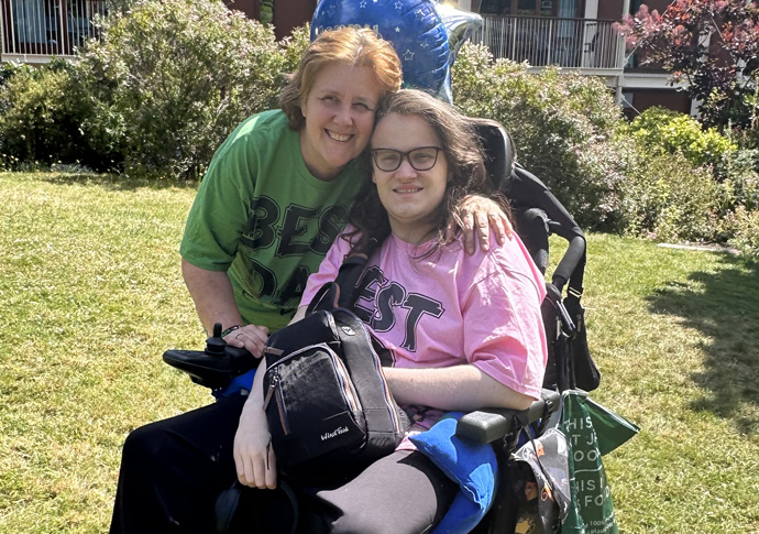 Carer is left unable to cook and without a shower for her son Tracey and her son Daniel outside Trinity Hospice where her husband died in July